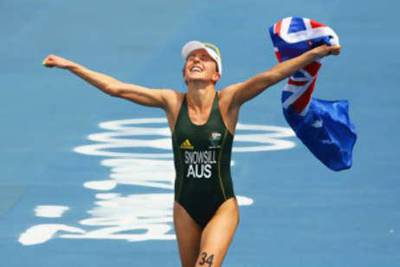 Emma Snowsill of Australia celebrates after taking the gold medal in the women's triathlon event.