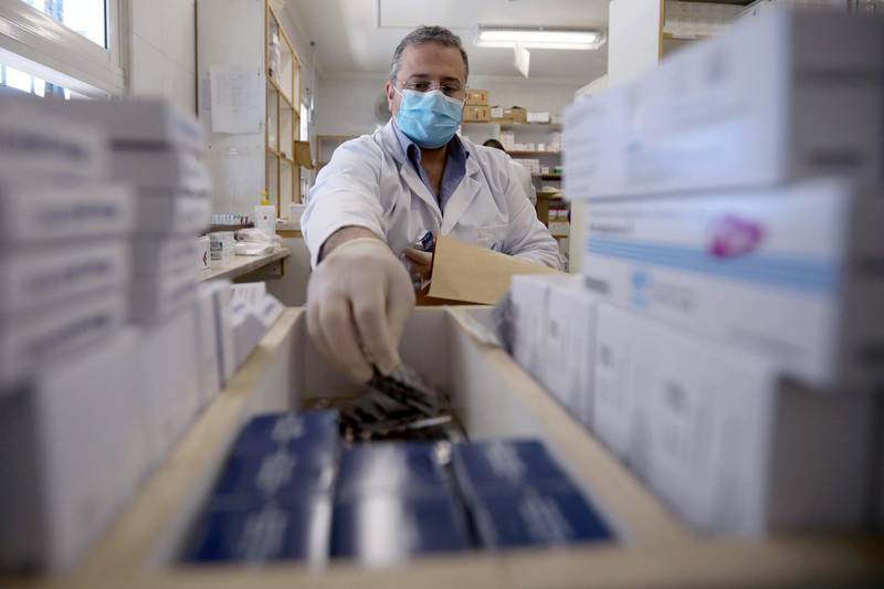 A member of the medical staff at UNRWA prepares prescription medicines to deliver to Palestinian refugees. REUTERS