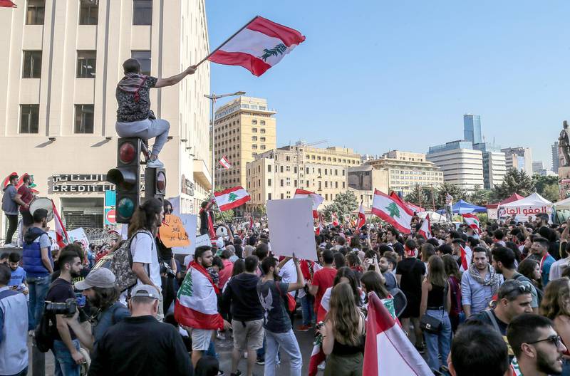 Lebanese students from various Universities carry placards and wave national flags during a protest in Beirut, Lebanon.  EPA