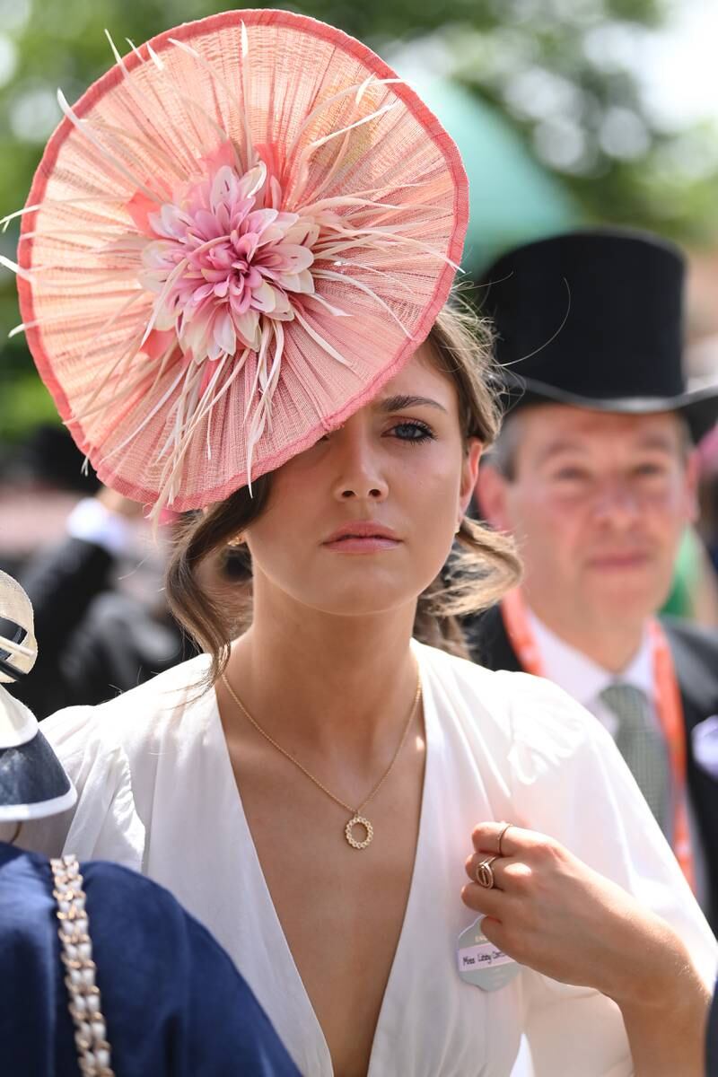 A racegoer dons an oversized floral fascinator. Getty Images for Ascot Racecourse