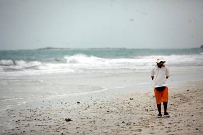 March 21, 2013 (Abu Dhabi) A life guard walks along the Saadiyat Public Beach as high winds kick up the surf in Abu Dhabi March 21, 2013. (Sammy Dallal / The National)