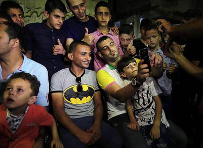 Palestinian singer Adel Meshoukhi, centre left, posing for pictures during a wedding in Rafah in the southern Gaza Strip. Meshoukhi is the kind of singer that perhaps only Gaza could produce: an Internet sensation who depends on a modest stipend from Hamas. Said Khatib/AFP