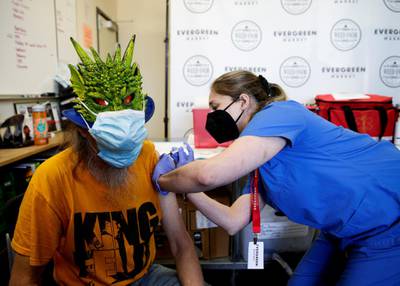 Street performer Keith Sexton receives the Covid-19 vaccine at the Evergreen Market cannabis store in Auburn, Washington State, US. Reuters