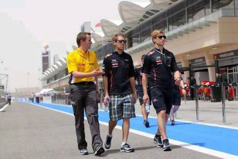 Sebastian Vettel, centre, is looking forward to getting on with the job of driving his Red Bull Racing car in practice in Bahrain.