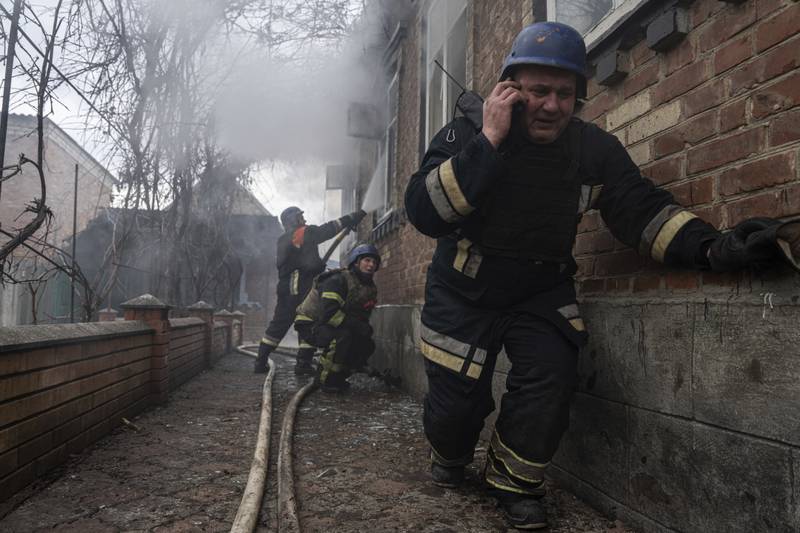 Rescue workers put out a fire in a house shelled by Russian forces in Kostiantynivka. AP