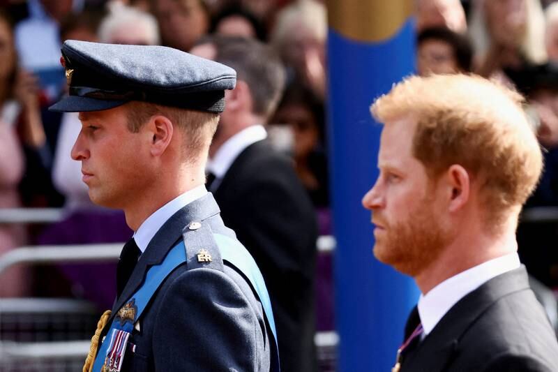 Prince William and Prince Harry march during a procession to bring their late grandmother's coffin to the Houses of Parliament for her lying in state. Reuters