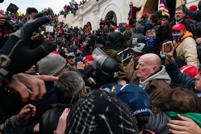 Demonstrators drag and capture a Metropolitan Police officer, while attempting to enter the U.S. Capitol building, during a protest in Washington, D.C., U.S., on Wednesday, Jan. 6, 2021. Bloomberg