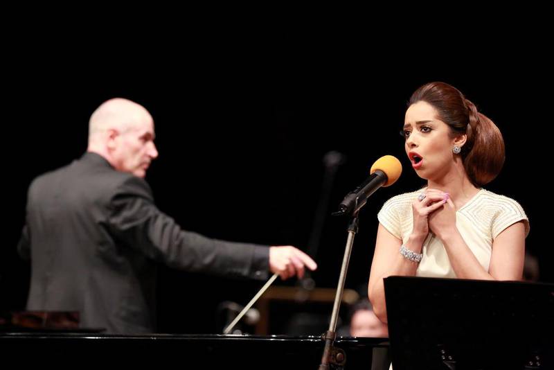 The National Symphony Orchestra conductor Andy Berryman, left, and the Emirati soprano Balqees Al Fathi perform at the ABu Dhabi National Theatre. Courtesy NSO