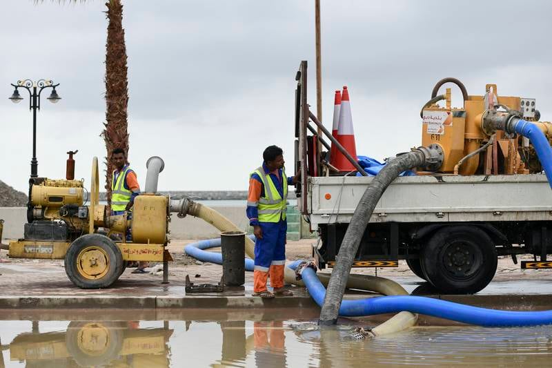 Municipality workers clean up an area affected by floods in Fujairah. Khushnum Bhandari / The National