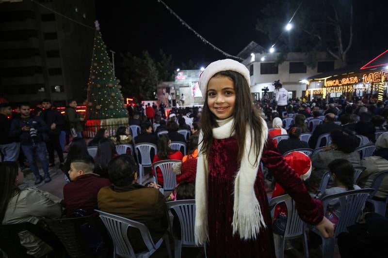 A young guest in festive colours at the Christmas tree lighting ceremony in Gaza city.