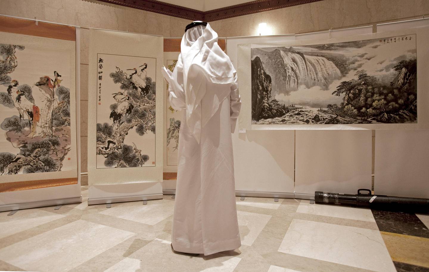 Dubai, March 23, 2011 - Ahmed Al Amiri looks an exhibit of Chinese drawings during the opening of the Confucius Institute a the University of Dubai in Al Mamzar, Dubai, March 23, 2011. (Jeff Topping/The National)
