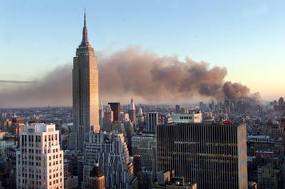 Smoke pours from the site and drifts across the New York sky. Reuters