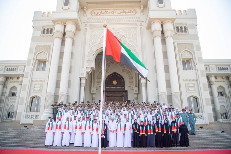 Sharjah Consultative Council raises the flag in front of its building in Sharjah