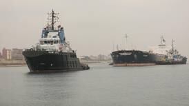 Suez Canal tug boats free ship stuck in waterway