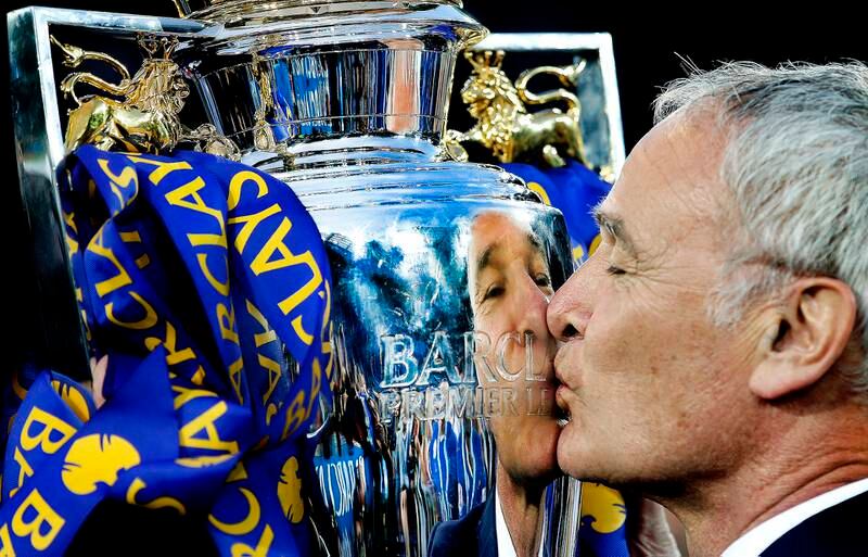 THE WINNER: Leicester City manager Claudio Ranieri kisses the Barclays Premier League Trophy after delivering the fairytale title to the club. 07/05/2016. Carl Recine / FPA / LDY Agency