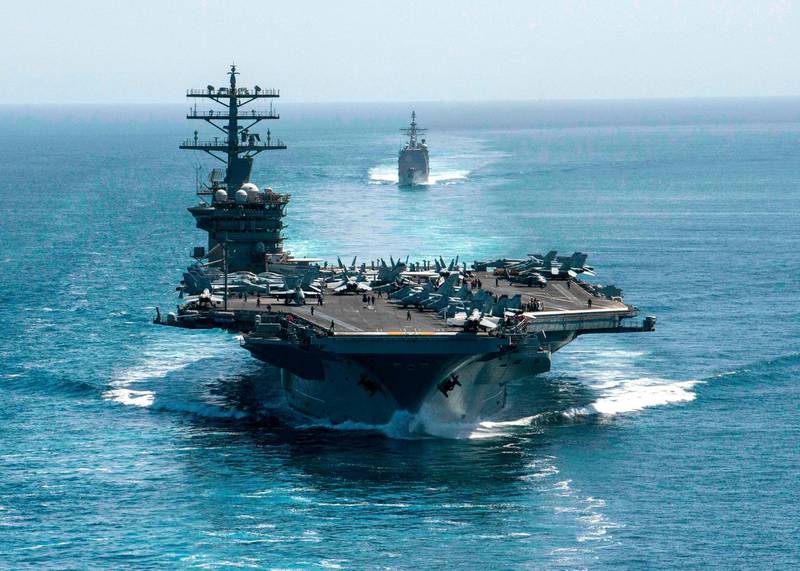  (FILES) In this file handout photo taken on September 18, 2020 and released by the US Navy, shows the aircraft carrier USS Nimitz and the guided-missile cruiser USS Philippine Sea in formation during a Strait of Hormuz transit. US President Joe Biden's administration has pulled the USS Nimitz carrier strike group out of the Gulf in a sign of potentially easing tensions with Iran, which had soared under former president Donald Trump. Pentagon spokesman John Kirby said on February 2, 2021, the Nimitz group had sailed from the US military's Central Command in the Middle East to the Indo-Pacific Command region. Kirby did not confirm reports the Nimitz was headed back to the US after some nine months at sea. - RESTRICTED TO EDITORIAL USE - MANDATORY CREDIT "AFP PHOTO / US NAVY /  Petty Officer 3rd Class Elliot Schaudt" - NO MARKETING - NO ADVERTISING CAMPAIGNS - DISTRIBUTED AS A SERVICE TO CLIENTS
 / AFP / US NAVY / US NAVY / US NAVY / elliot Schaudt / RESTRICTED TO EDITORIAL USE - MANDATORY CREDIT "AFP PHOTO / US NAVY /  Petty Officer 3rd Class Elliot Schaudt" - NO MARKETING - NO ADVERTISING CAMPAIGNS - DISTRIBUTED AS A SERVICE TO CLIENTS
