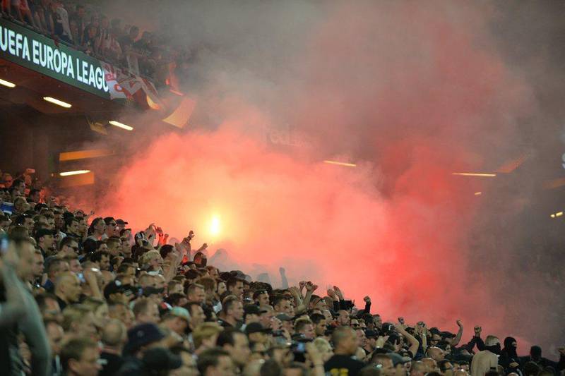 Ajax supporters set off a flare inside the Friends Arena during the Europa League final. Peter Powell / EPA