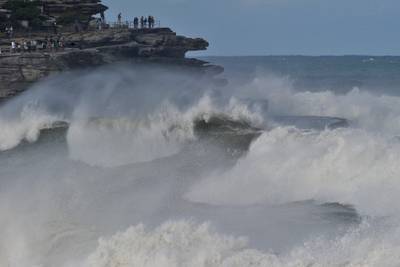 Residents watch big waves crashing on to the rocks at Bondi Beach in Sydney, Australia. AFP
