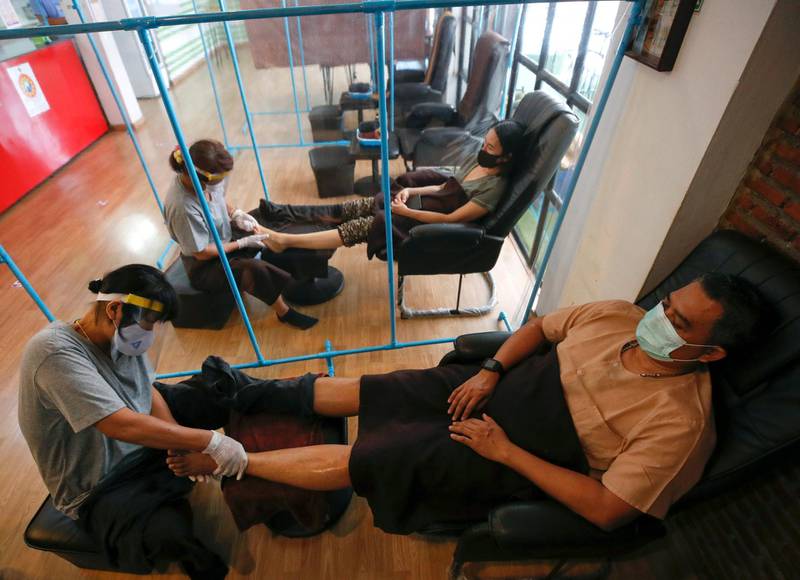 Customers receive foot massage from Thai masseuses in Bangkok, Thailand.  EPA
