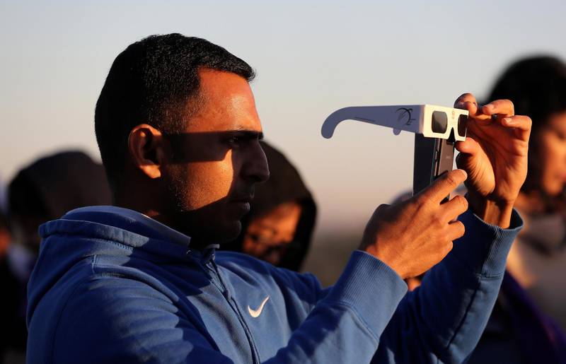 DUBAI, UNITED ARAB EMIRATES, Dec 26 – 2019 :- One of the person taking photo of the solar eclipse with his mobile phone at the Al Thuraya Astronomy Center in Mushrif park in Dubai. ( Pawan Singh / The National ) For News/Instagram 