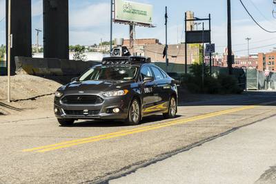 A passenger looks on as an Uber self-driving car taks to the roads in Pittsburgh, Pennsylvania. Intel plans to take the lead in the autonomous vehicle sector with the purchase of Mobileye. Angelo Merendino / AFP