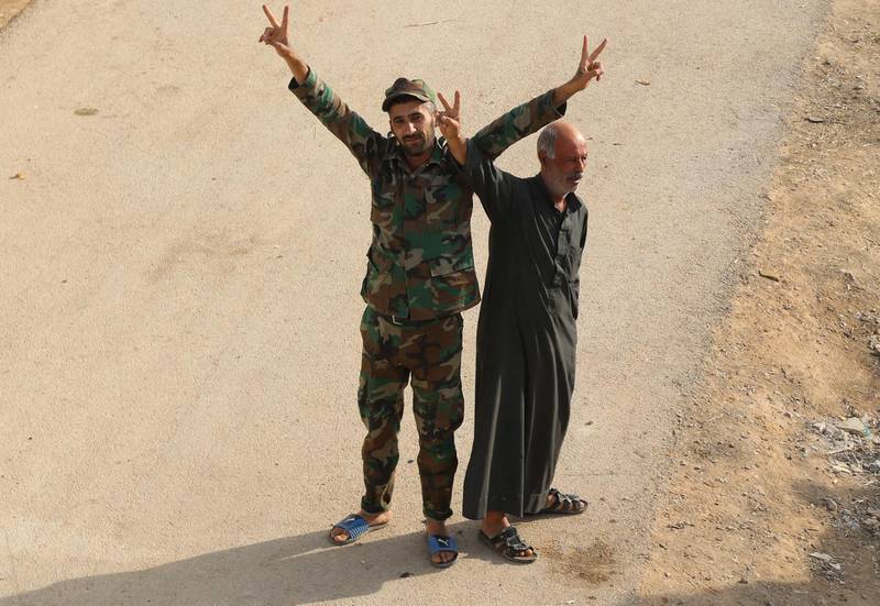 A Syrian soldier and a local man cheer after the Syrian Arab Army completed its deployment in the city of Manbej and its surroundings in Aleppo provinces northeastern countryside, Syria. According to media reports, the soldiers were welcomed by the locals, who have gathered in the city center, carrying Syrian flags and cheering for the army which came to encounter the Turkish aggression.  EPA