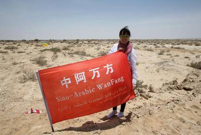 A Chinese investor posea for a picture in the land where an industrial city, including an oil refinery, is due to be built following an economic agreement, in the port town of Duqm on May 24, 2016 .
Chinese investors signed a deal with Oman's government to establish an industrial city, including an oil refinery, in the port town of Duqm, both sides said in a joint statement. The agreement signed during the ceremony in Muscat would open way for investments worth $10.7 billion by 2022 to finance industrial projects in Duqm, on the Arabian Sea, which the Omani government is developing in a bid to diversify revenues beyond oil. / AFP PHOTO / MOHAMMED MAHJOUB