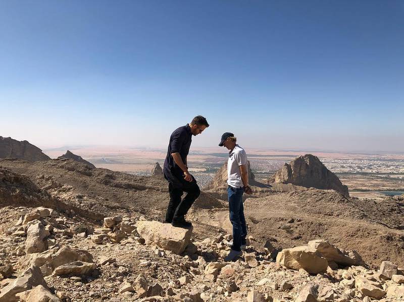 Reynolds in discussion with 6 Underground director, Michael Bay, on a rocky mountainous outcrop on Jebel Hafeet. Courtesy Ryan Reynolds