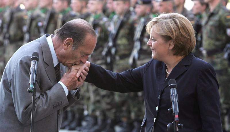 BERLIN - MAY 03:  French President Jacques Chirac kisses the hand of German Chancellor Angela Merkel upon his arrival at the Chancellery May 3, 2007 in Berlin, Germany. Chirac is on his last trip to Germany as French president. During his term in office he forged close relations between the two countries. Behind the two leaders stands a Franco-German joint military brigade.  (Photo by Sean Gallup/Getty Images)