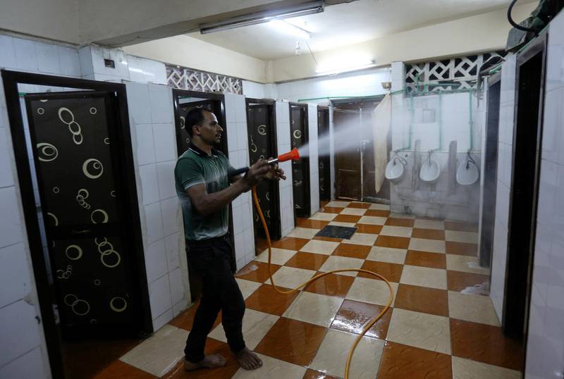 A volunteer sprays disinfectant in bathrooms at a Cairo mosque as it prepares to receive worshippers.  Reuters