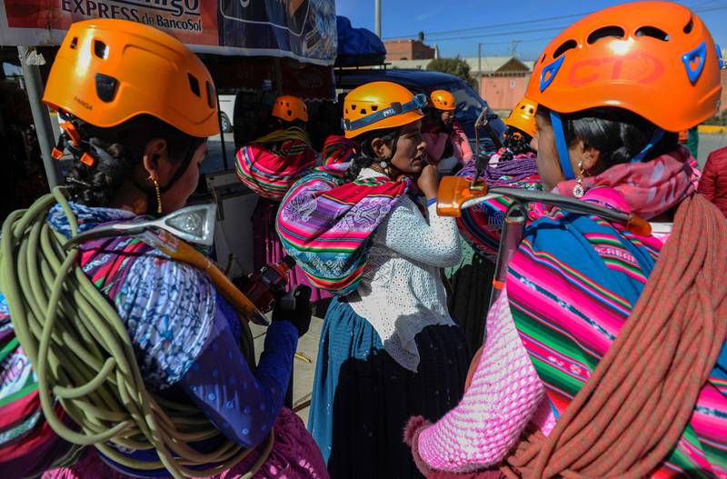 Aymara indigenous women climbers waiting for the bus to take them to the base of Huayna Potosi.