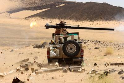 FILE PHOTO: A Yemeni government fighter fires a vehicle-mounted weapon at a frontline position during fighting against Houthi fighters in Marib, Yemen March 9, 2021. Picture taken March 9, 2021. REUTERS/Ali Owidha/File Photo