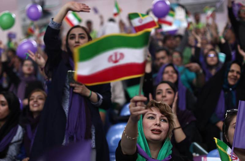 Supporters of Iranian President Hassan Rouhani chant slogans during a election rally in 2017.
