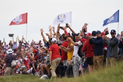 Spectators cheer on the players on the 16th green during day three of the Ryder Cup. PA
