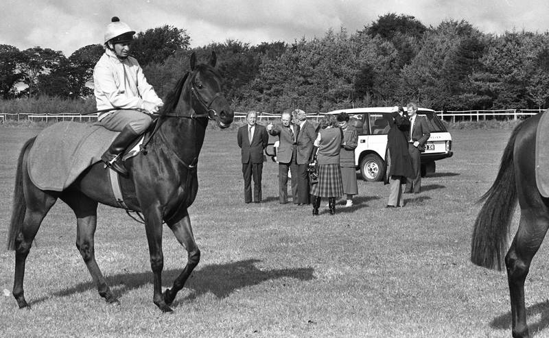 Charles Haughey, background left, at Ballydoyle Stables, Tipperary, in 1987. Getty