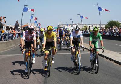Team Jumbo–Visma rider Jonas Vingegaard wearing the white jersey, UAE Team Emirates rider Tadej Pogacar wearing the yellow jersey, Deceuninck–Quick-Step rider Mark Cavendish wearing the green jersey, and Bahrain Victorious rider Wout Poels with the polka dot jersey.