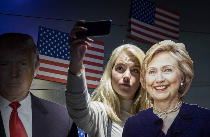 Visitors take a selfie with portraits of presidential candidates Hillary Clinton and Donald Trump during US election night in The Hague, Netherlands, during the 2016 presidential election race. EPA