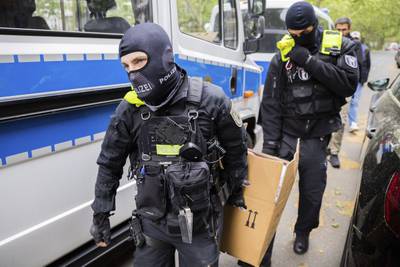 Police remove items during a raid in Berlin related to an investigation into the Last Generation climate activist group. AP