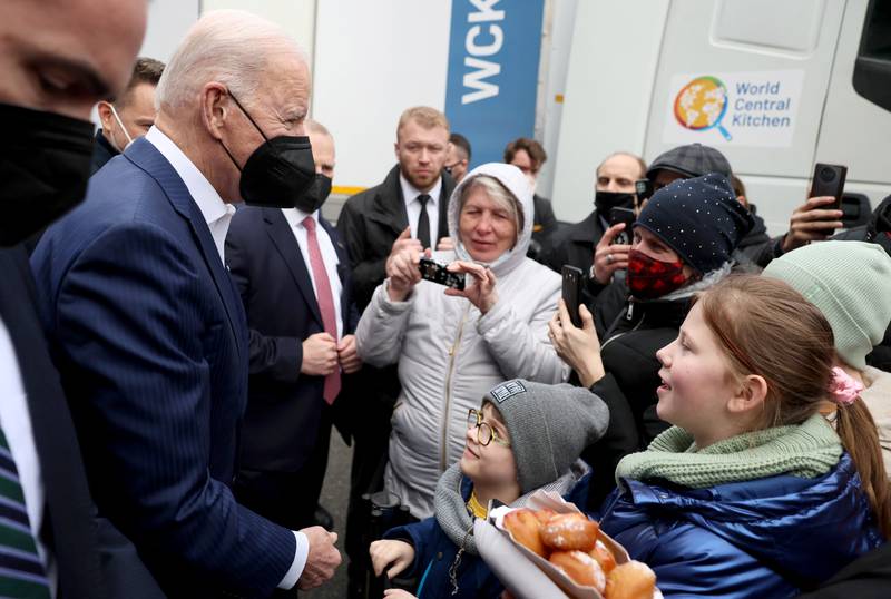 Mr Biden talks to children of Ukrainian refugees. Reuters