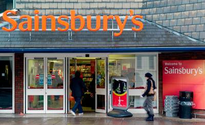 FILE - In this file photo dated Wednesday, Nov. 11, 2009, people enter a Sainsbury's store in south London. Sainsburyâ€™s, the U.K.â€™s second-biggest grocery chain, said Saturday April 28, 2018, it is in advanced discussions about a merger with Walmart Inc.â€™s British unit, Asda. (AP Photo/Sang Tan, FILE)