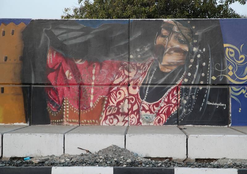 A woman in an abaya by Malak Gallery. 