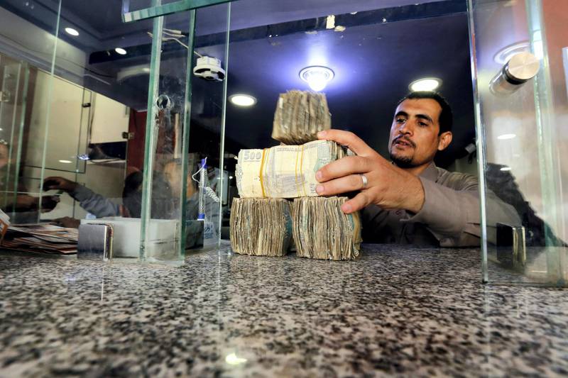 epa06990494 A Yemeni man holds Yemeni currency banknotes amid a continuous collapse of the Rial currency, at a currency exchange office in Sana?a, Yemen, 01 September 2018. According to reports, the Yemeni currency Rial has lost more than 100 percent in value against the US dollar where the exchange rate of the YR against one dollar amounted to about 600 YR compared to 250 YR at the beginning of the over three-year conflict in the Arab world's poorest country.  EPA-EFE/YAHYA ARHAB *** Local Caption *** 54595351