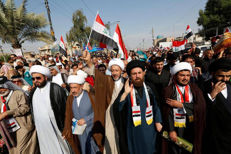 Iraqi demonstrators and clerics gather after Friday prayer during ongoing anti-government protests in Sadr City district of Baghdad. Reuters