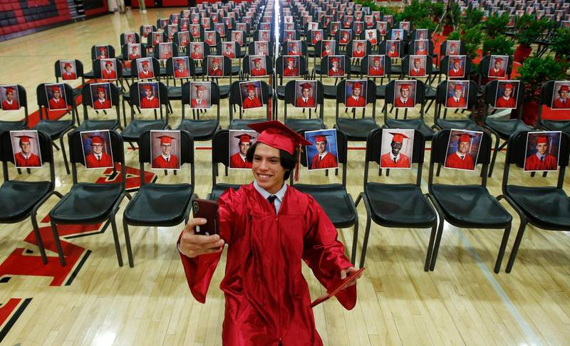 Paul Santiago Kelley, a graduating senior at Brophy College Preparatory, smiles as he takes a selfie as he celebrates Diploma Days with photos of all his fellow classmates in Phoenix, Arizona, USA. AP Photo
