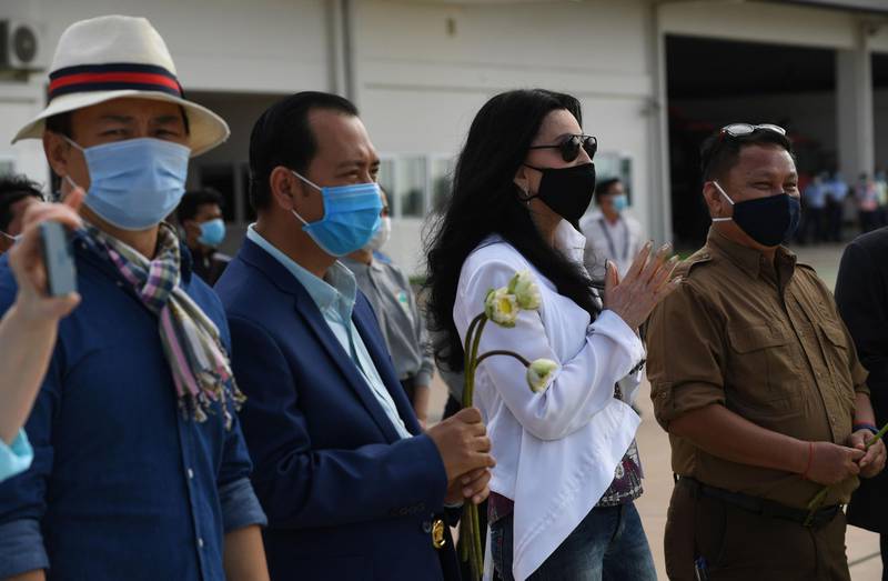 Cher and Cambodia's Deputy Minister of Environment Neth Pheaktra  await the arrival of a crate containing Kaavan the elephant from Pakistan at Siem Reap International Airport. AFP
