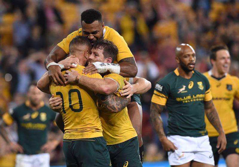 Australia's Bernard Foley, centre, celebrates after scoring a try during the Rugby Championship match between the Australian Wallabies and the South African Springboks. Dave Hunt / EPA
