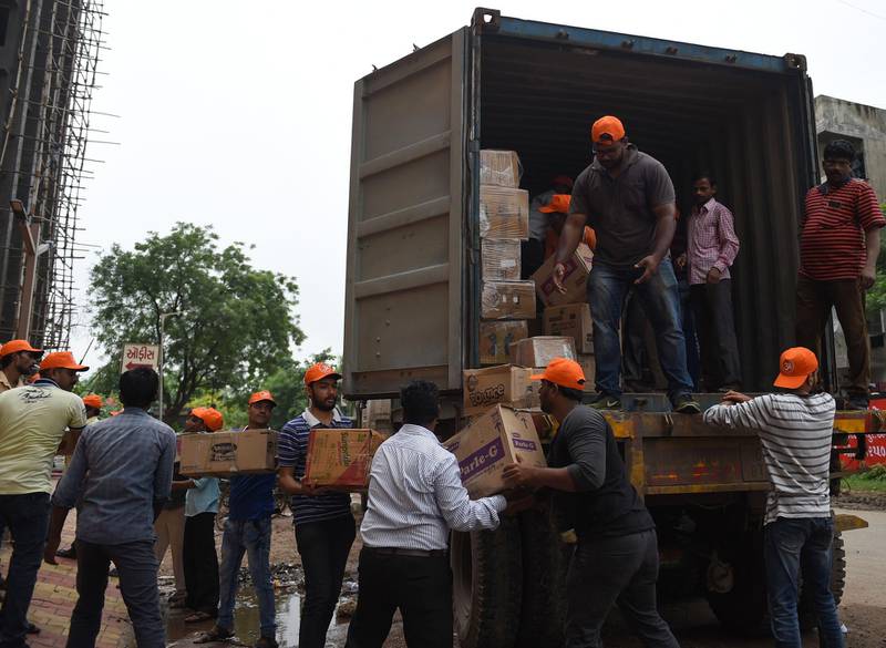 Indian volunteers from the Haridwar Mitra Mandal Charitable Trust load aid packets to be shipped to flood-hit Kerala, in Ahmedabad. AFP
