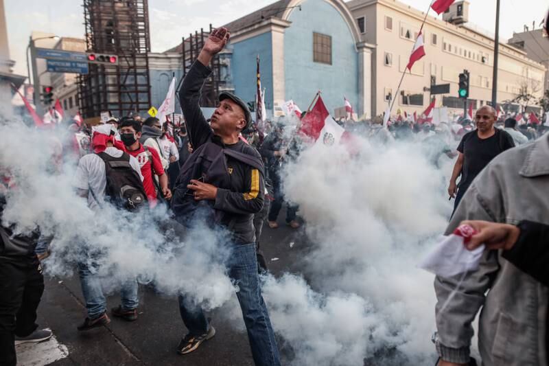 People confront Peruvian police during a march against President Pedro Castillo in Lima. EPA
