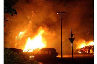 Cars burn on July 17 in the Grenoble suburb of Villeneuve, home of Karim Boudouda, a supermarket robber killed by the police the previous night.