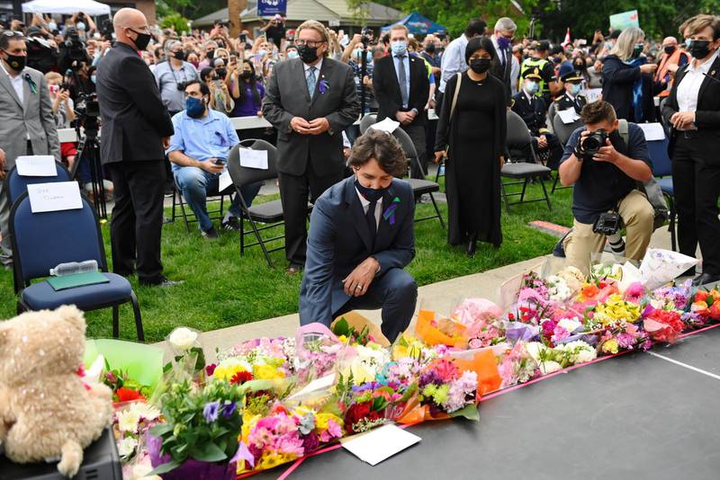 Canada's Prime Minister Justin Trudeau lays flowers at a vigil outside the London Muslim Mosque for the victims of the deadly vehicle attack on five members of the Canadian Muslim community in London, Ontario, on Tuesday, June 8, 2021. Four of the members of the family died and one is in critical condition. Police have charged a London man with four counts of murder and one count of attempted murder. (Nathan Denette/The Canadian Press via AP)
